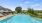 large, swimming pool surrounded by lounge chairs