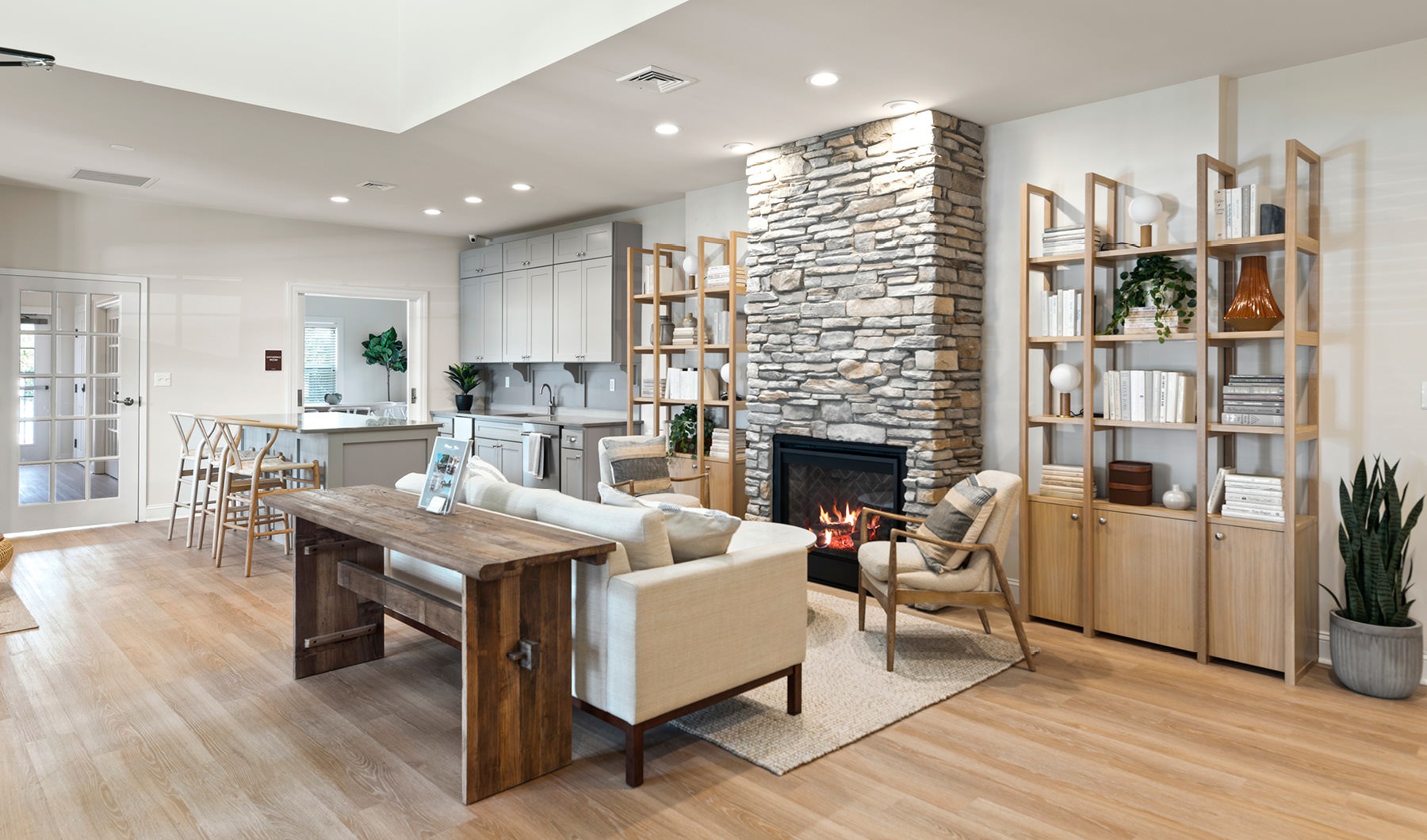 Join Our Community Resident clubroom with fireplace and ample natural lighting