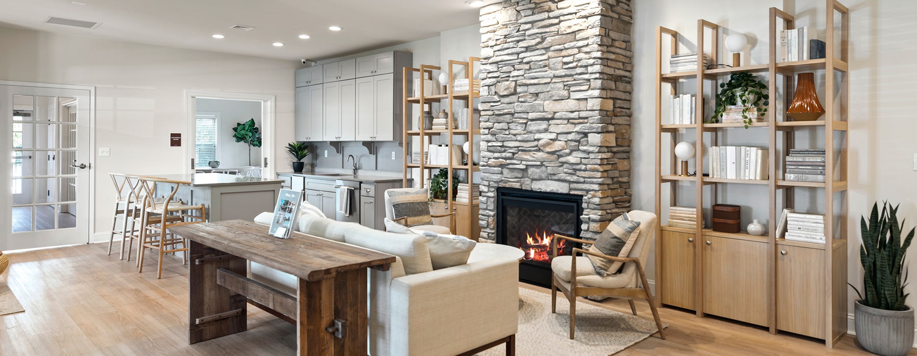 Resident clubroom with fireplace and ample natural lighting